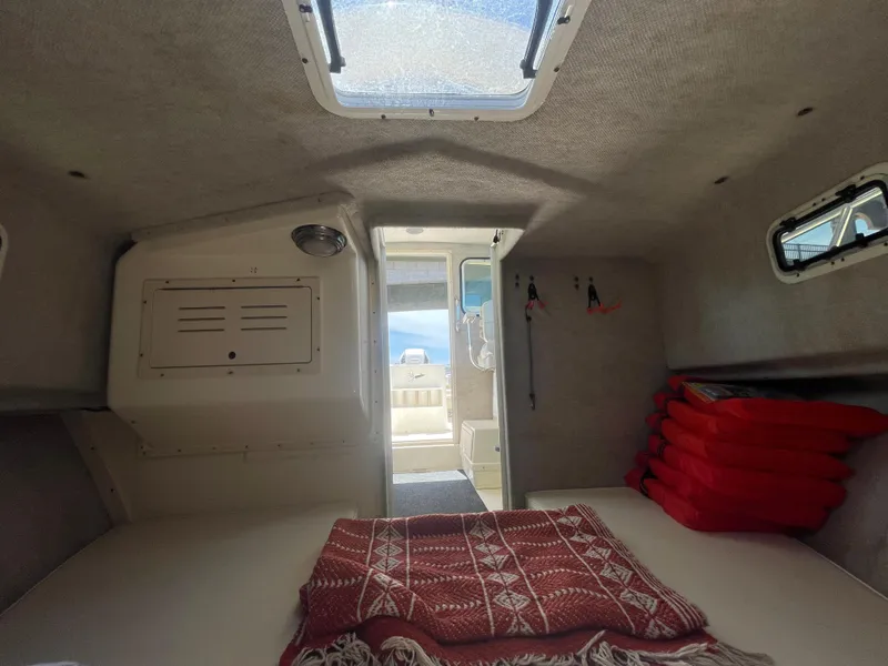 Slide: The Image of 2008 Parker 2520 XL Sport Cabin interior with skylight and red life jackets. - 28