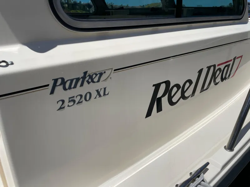 Slide: The Image of 2008 Parker 2520 XL Sport Cabin boat with "Reel Deal" name on the side. - 29