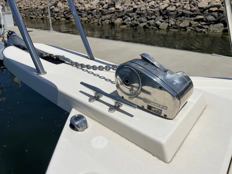 Slide: The Image of Anchor winch on 2008 Parker 2520 XL Sport Cabin boat, docked by rocky shore. - 3