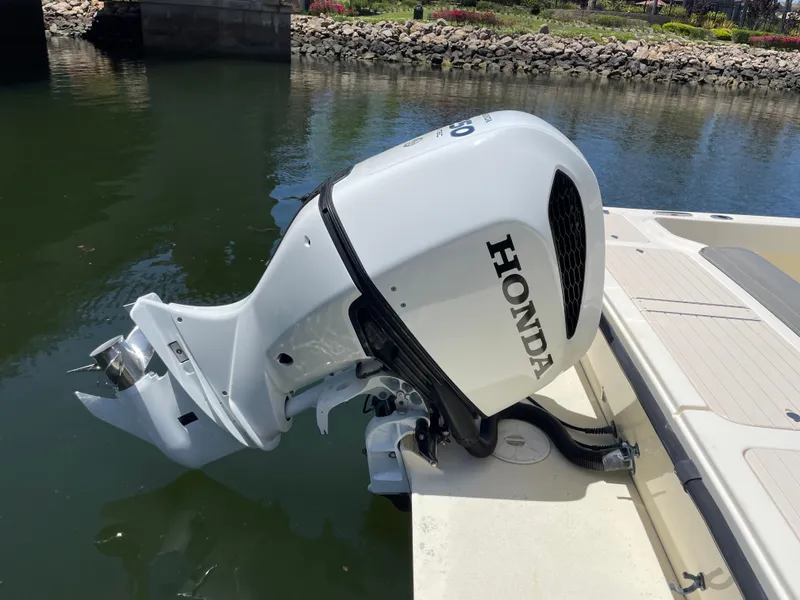Slide: The Image of Honda outboard motor on 2008 Parker 2520 XL Sport Cabin boat, docked by water. - 30