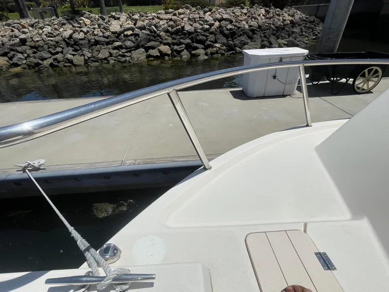 Slide: The Image of 2008 Parker 2520 XL Sport Cabin boat docked near rocky shoreline. - 4