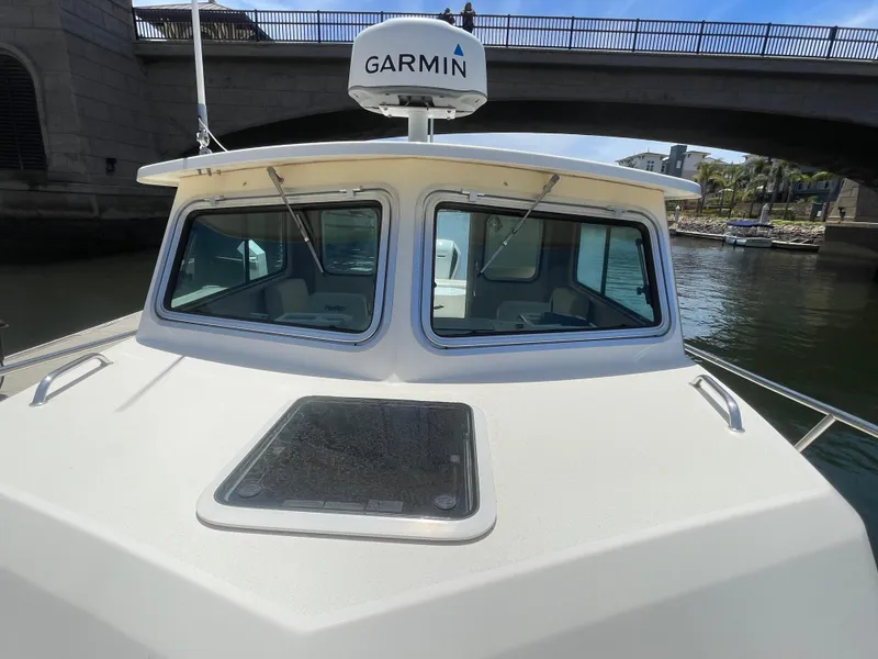 Slide: The Image of 2008 Parker 2520 XL Sport Cabin boat with Garmin radar, under a bridge. - 5