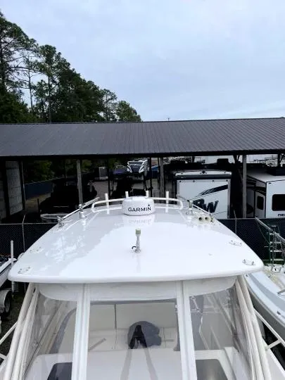 Slide: The Image of 2007 Intrepid 35 Walkaround boat with Garmin equipment, docked near RVs and trees. - 17