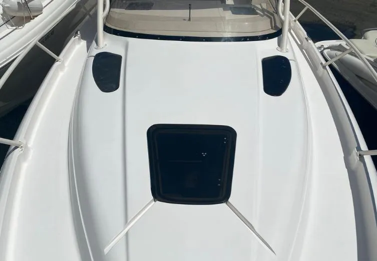 Slide: The Image of 2007 Intrepid 35 Walkaround boat deck with hatch and sleek design. - 18