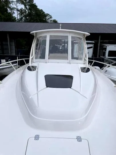 Slide: The Image of 2007 Intrepid 35 Walkaround boat, white exterior, docked near other vessels. - 19