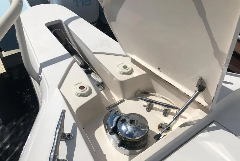 Slide: The Image of 2007 Intrepid 35 Walkaround boat deck with open storage compartment and chrome fittings. - 20