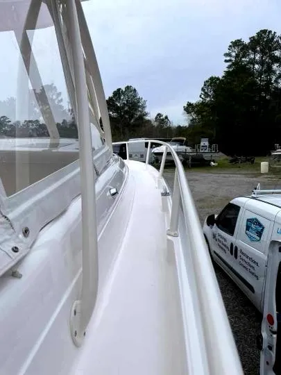 Slide: The Image of 2007 Intrepid 35 Walkaround boat side view with trees and vehicles in the background. - 27