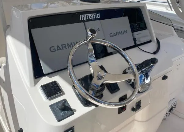 Slide: The Image of 2007 Intrepid 35 Walkaround helm with Garmin navigation system and chrome steering wheel. - 3