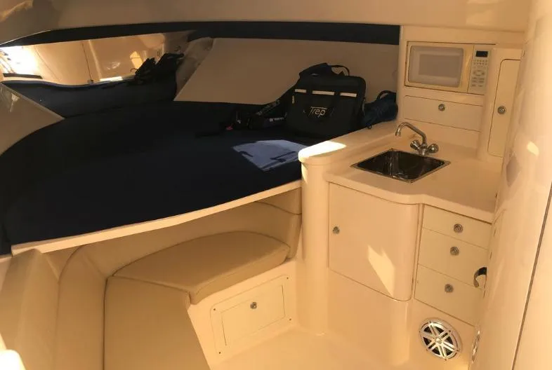 Slide: The Image of 2007 Intrepid 35 Walkaround cabin interior with kitchenette and seating area. - 8
