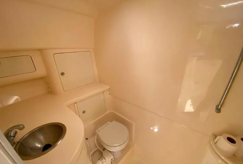 Slide: The Image of 2007 Intrepid 35 Walkaround boat bathroom with sink, toilet, and storage cabinets. - 9