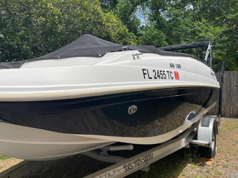 The Image of 2022 Hurricane SunDeck Sport 188 OB boat on trailer, parked outdoors. - 0