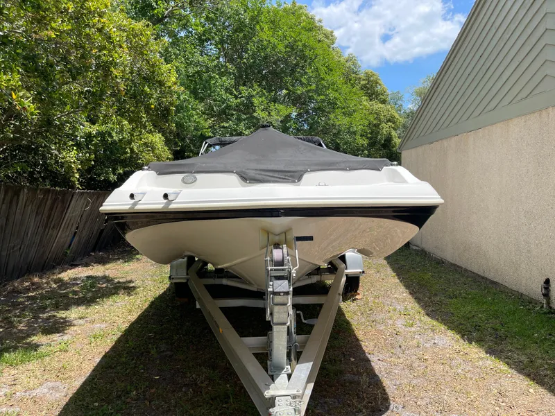 Slide: The Image of 2022 Hurricane SunDeck Sport 188 OB boat on trailer, parked outdoors. - 14