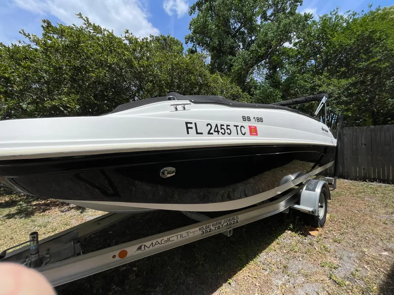 Slide: The Image of 2022 Hurricane SunDeck Sport 188 OB boat on trailer, parked outdoors. - 4