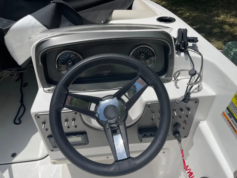 Slide: The Image of 2022 Hurricane SunDeck Sport 188 OB boat dashboard with steering wheel and controls. - 6