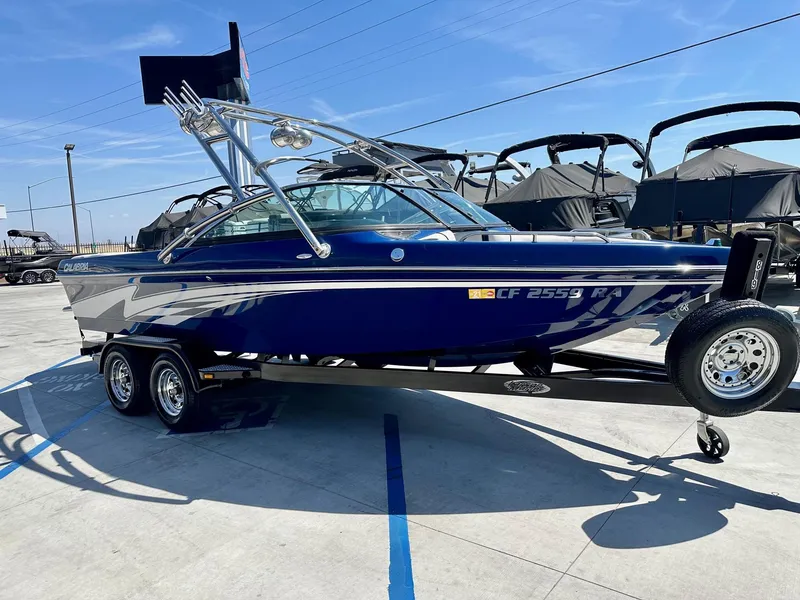 Slide: The Image of 2006 Calabria Boats Wakeboard Boat Cal-Air Pro-V on trailer in sunny marina. - 4