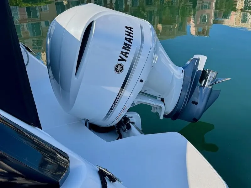 Slide: The Image of 2020 Regal 26 XO boat with Yamaha outboard motor on calm water. - 10