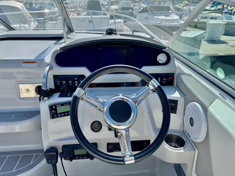 Slide: The Image of Cockpit of 2020 Regal 26 XO boat with steering wheel and control panel. - 21