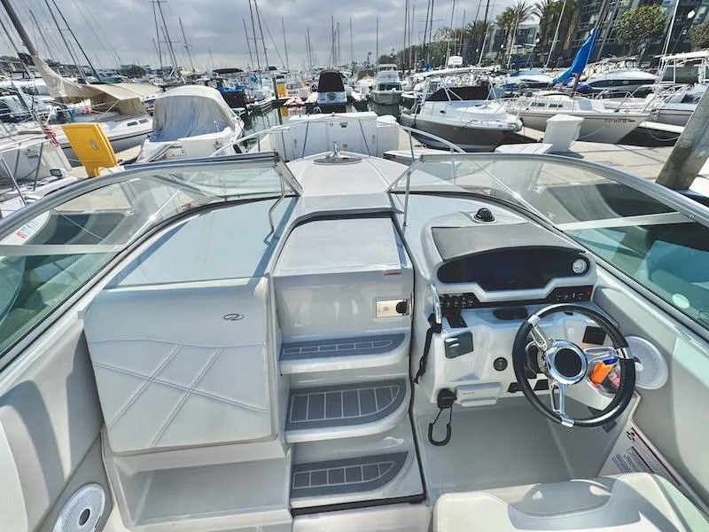 Slide: The Image of 2020 Regal 26 XO boat interior at marina, featuring helm and seating area. - 22