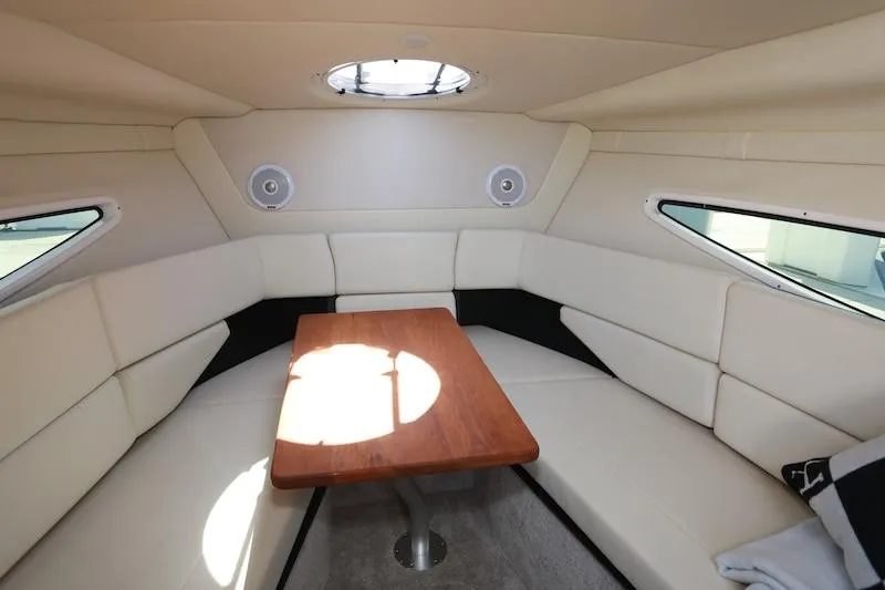 Slide: The Image of Interior of 2020 Regal 26 XO boat with white seating and wooden table. - 27