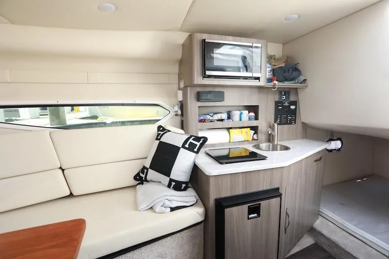 Slide: The Image of 2020 Regal 26 XO cabin interior with kitchenette, seating, and modern amenities. - 31