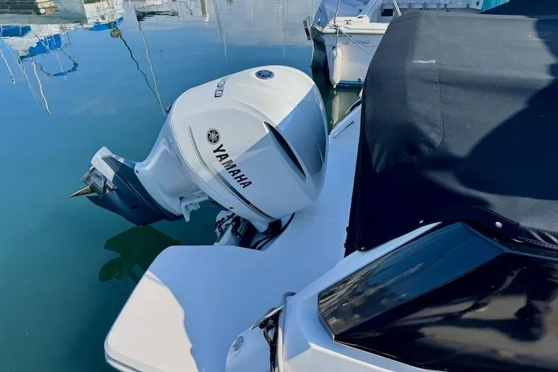 Slide: The Image of 2020 Regal 26 XO boat with Yamaha outboard engine docked at marina. - 9