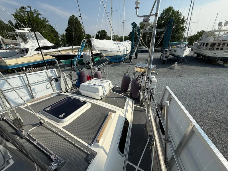 Slide: The Image of 1997 Westerly Oceanlord sailboat on dry dock, surrounded by other boats and trees. - 10