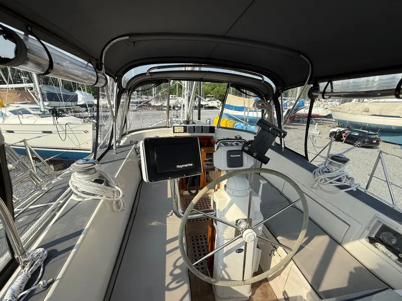 Slide: The Image of 1997 Westerly Oceanlord yacht cockpit with steering wheel and navigation equipment. - 12