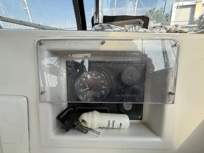 Slide: The Image of Control panel of a 1997 Westerly Oceanlord sailboat with keys and a white container. - 17