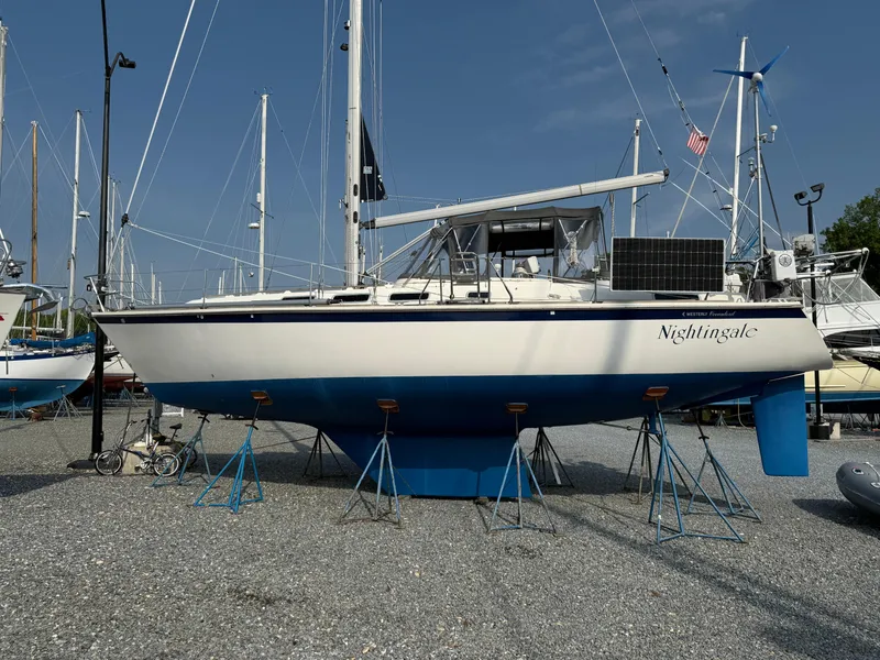 Slide: The Image of 1997 Westerly Oceanlord sailboat "Nightingale" on stands, displayed in a boatyard. - 2