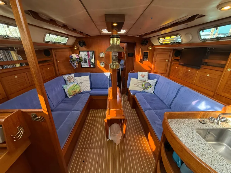 Slide: The Image of Luxurious 1997 Westerly Oceanlord yacht interior with blue seating and wooden finishes. - 30