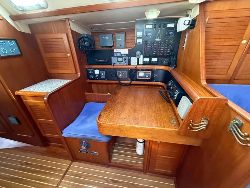 Slide: The Image of Navigation station of 1997 Westerly Oceanlord yacht with wooden interior and control panels. - 36