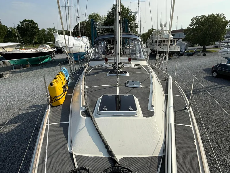 Slide: The Image of 1997 Westerly Oceanlord sailboat on gravel lot, surrounded by other boats and trees. - 7