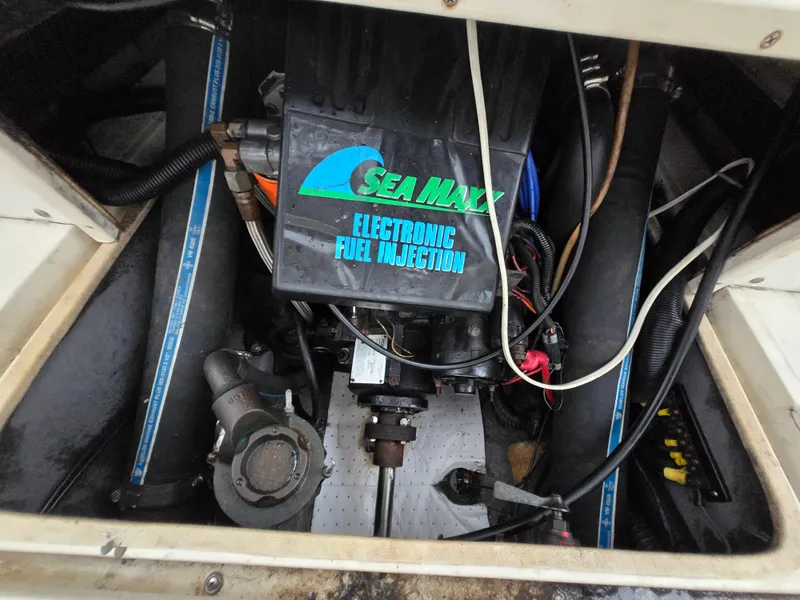 Slide: The Image of Engine compartment of a 1999 Shamrock 220 Open with Sea Maxx electronic fuel injection. - 18