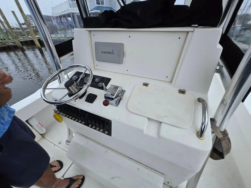 Slide: The Image of 1999 Shamrock 220 Open boat console with steering wheel and Garmin navigation system. - 4