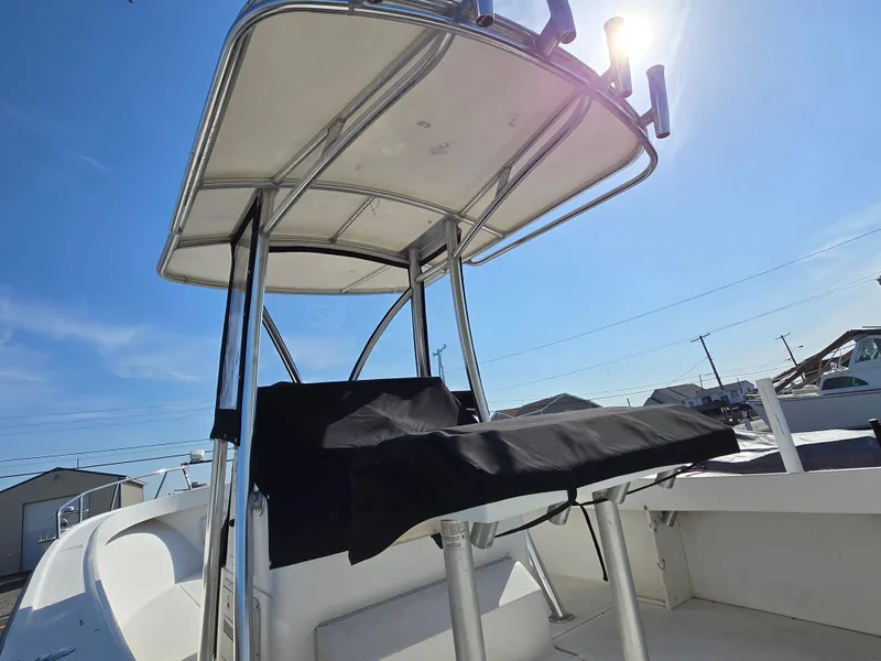 Slide: The Image of 1999 Shamrock 220 Open boat with T-top under clear blue sky. - 6