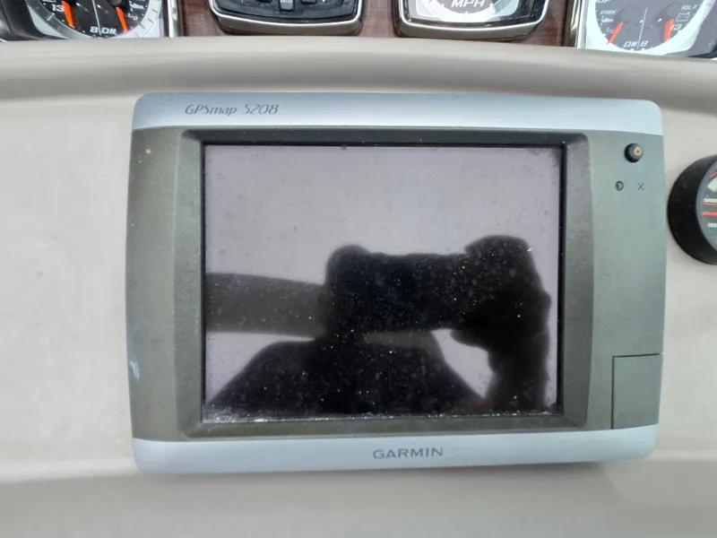 Slide: The Image of Garmin GPSmap 5208 on 2008 Chaparral 290 Signature dashboard, with reflection visible. - 18
