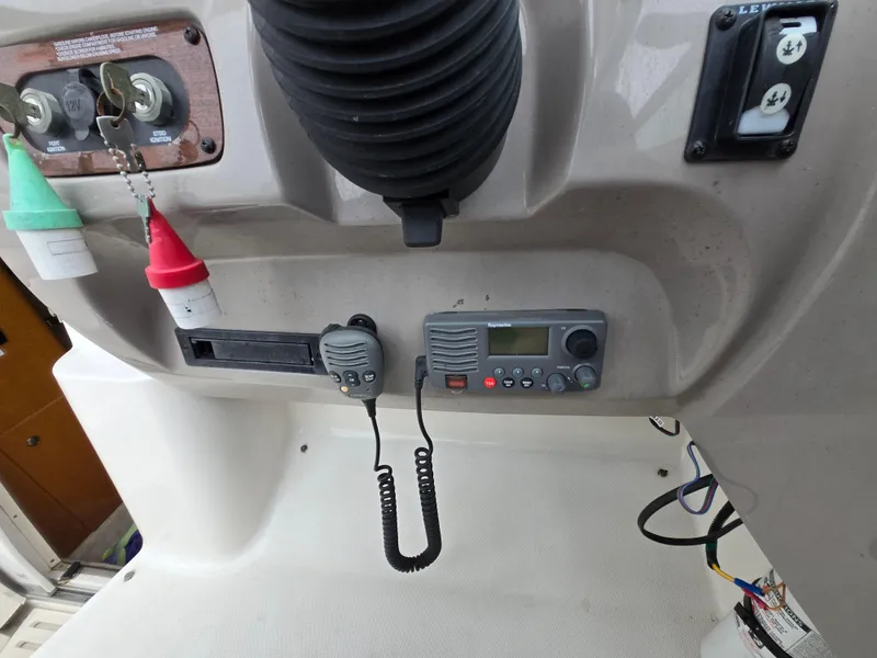 Slide: The Image of Control panel of a 2008 Chaparral 290 Signature boat with radio and safety equipment. - 19