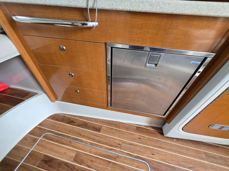 Slide: The Image of 2008 Chaparral 290 Signature interior with wood cabinetry and stainless steel appliance. - 20