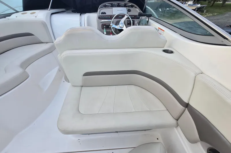 Slide: The Image of 2008 Chaparral 290 Signature boat interior with white seating and steering console. - 40