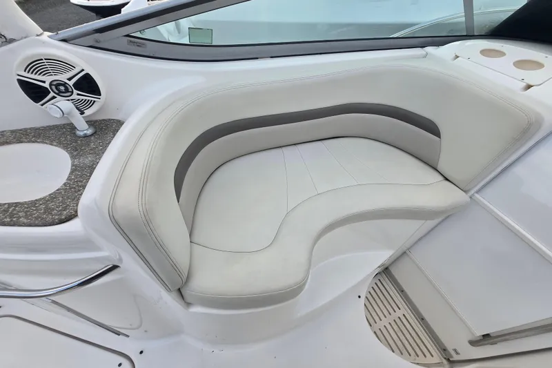 Slide: The Image of 2008 Chaparral 290 Signature boat interior with white cushioned seating and speaker. - 42