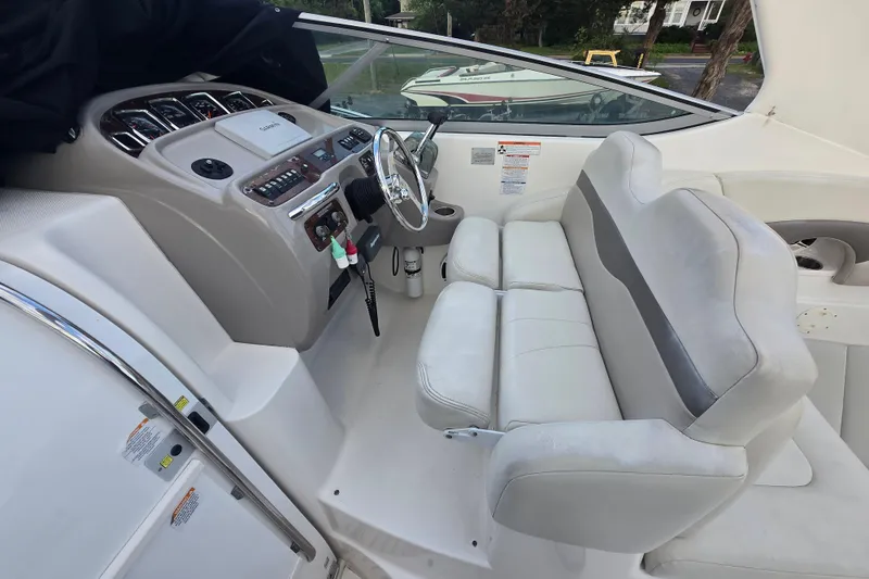Slide: The Image of 2008 Chaparral 290 Signature boat cockpit with steering wheel and seating area. - 43