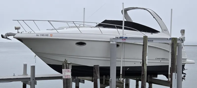 Slide: The Image of 2008 Chaparral 290 Signature boat docked on a lift, side view. - 8