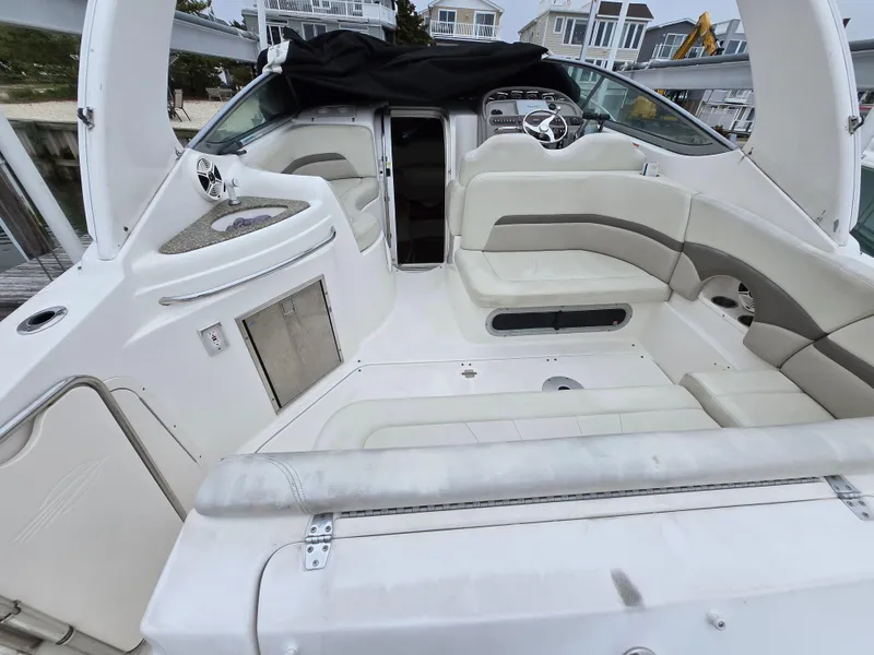 Slide: The Image of 2008 Chaparral 290 Signature boat interior with white seating and steering area. - 9