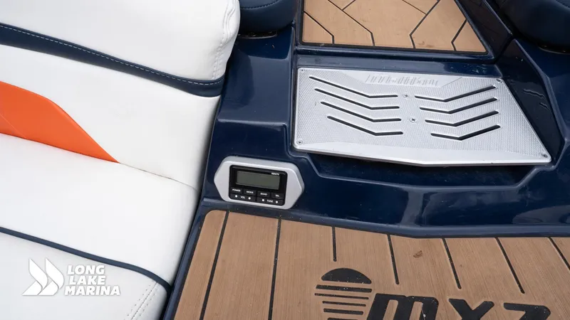 Slide: The Image of 2019 Malibu MXZ boat interior with custom seating and control panel, Long Lake Marina branding. - 10