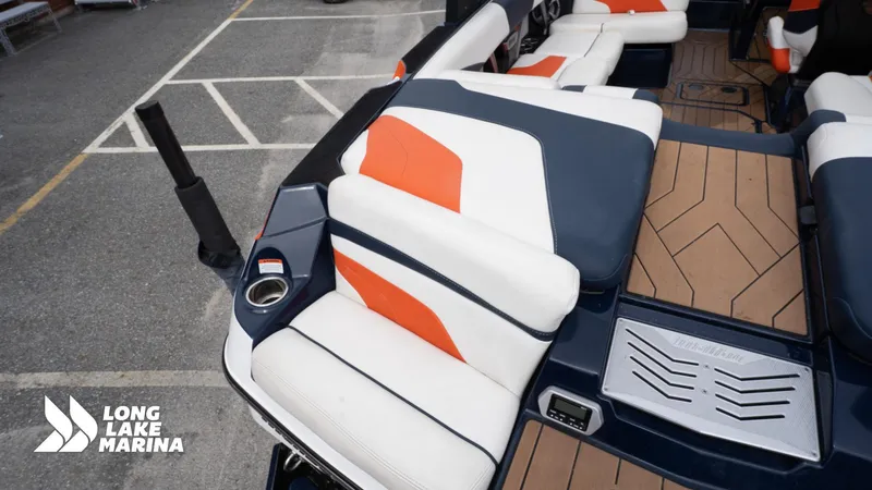 Slide: The Image of 2019 Malibu MXZ boat interior with orange and white seating at Long Lake Marina. - 11