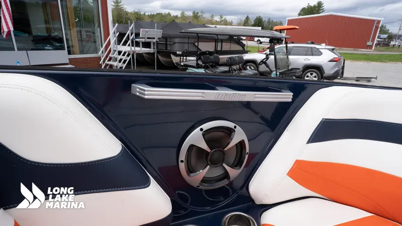 Slide: The Image of Interior of a 2019 Malibu MXZ boat with speaker and stylish seating at Long Lake Marina. - 14