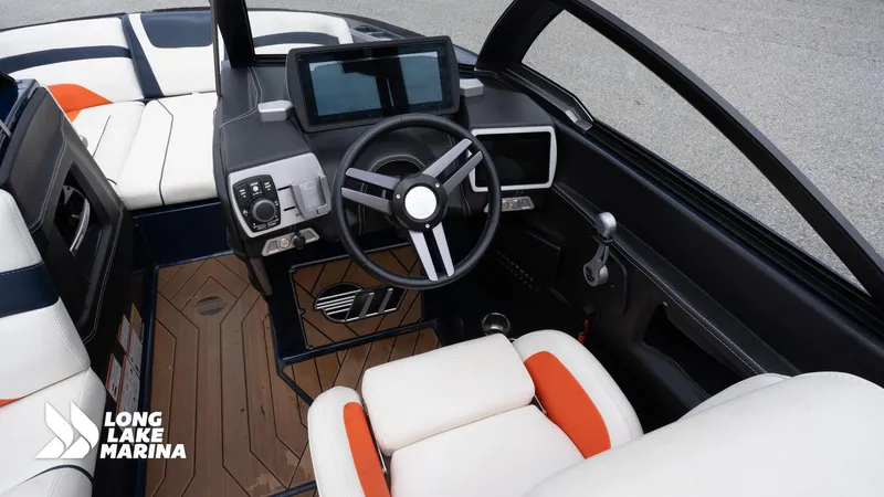 Slide: The Image of 2019 Malibu MXZ boat interior with steering wheel and dashboard at Long Lake Marina. - 15