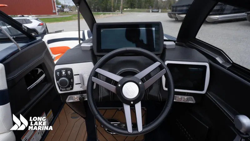 Slide: The Image of 2019 Malibu MXZ boat dashboard with modern controls and steering wheel at Long Lake Marina. - 16
