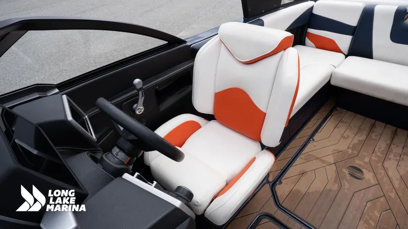 Slide: The Image of Interior of a 2019 Malibu MXZ boat with orange and white seating. - 17