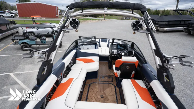 Slide: The Image of 2019 Malibu MXZ boat interior with orange and white seating at Long Lake Marina. - 21